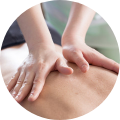 Hands on bare back performing massage therapy
